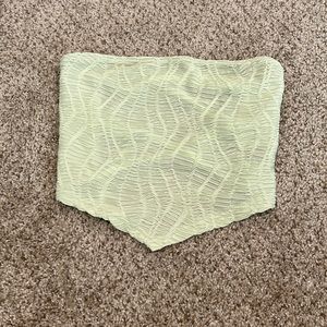 Sleeveless pastel green cropped top.